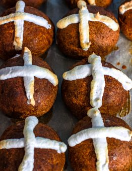 6 Keto Hot Cross Buns on a baking lined baking sheet