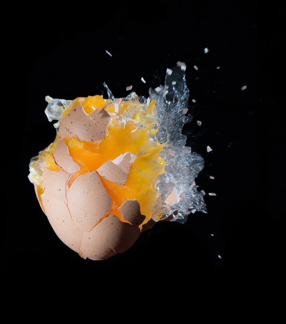 smashed egg on black background