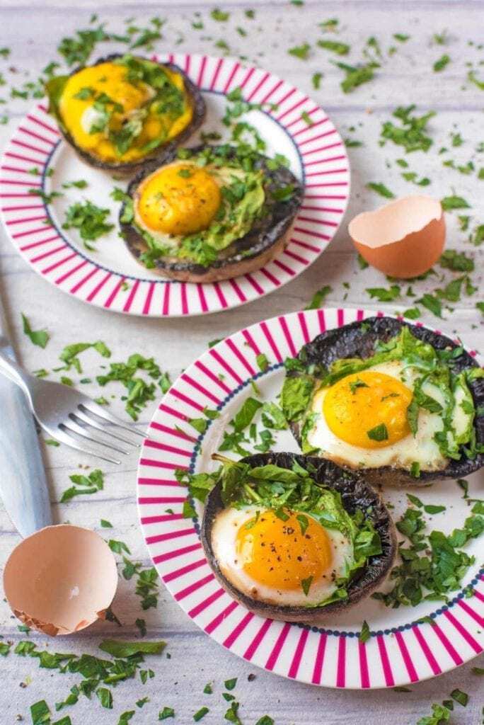 eggs in mushrooms on two plates