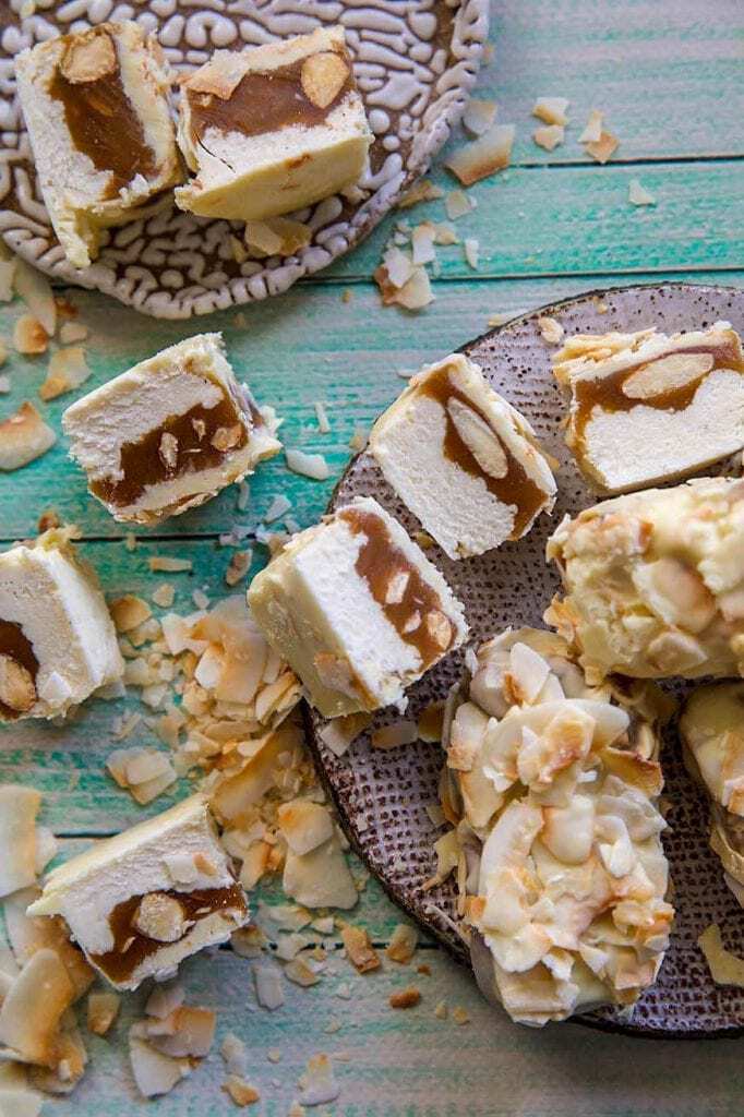 white chocolate snicker bars scattered on a wood background