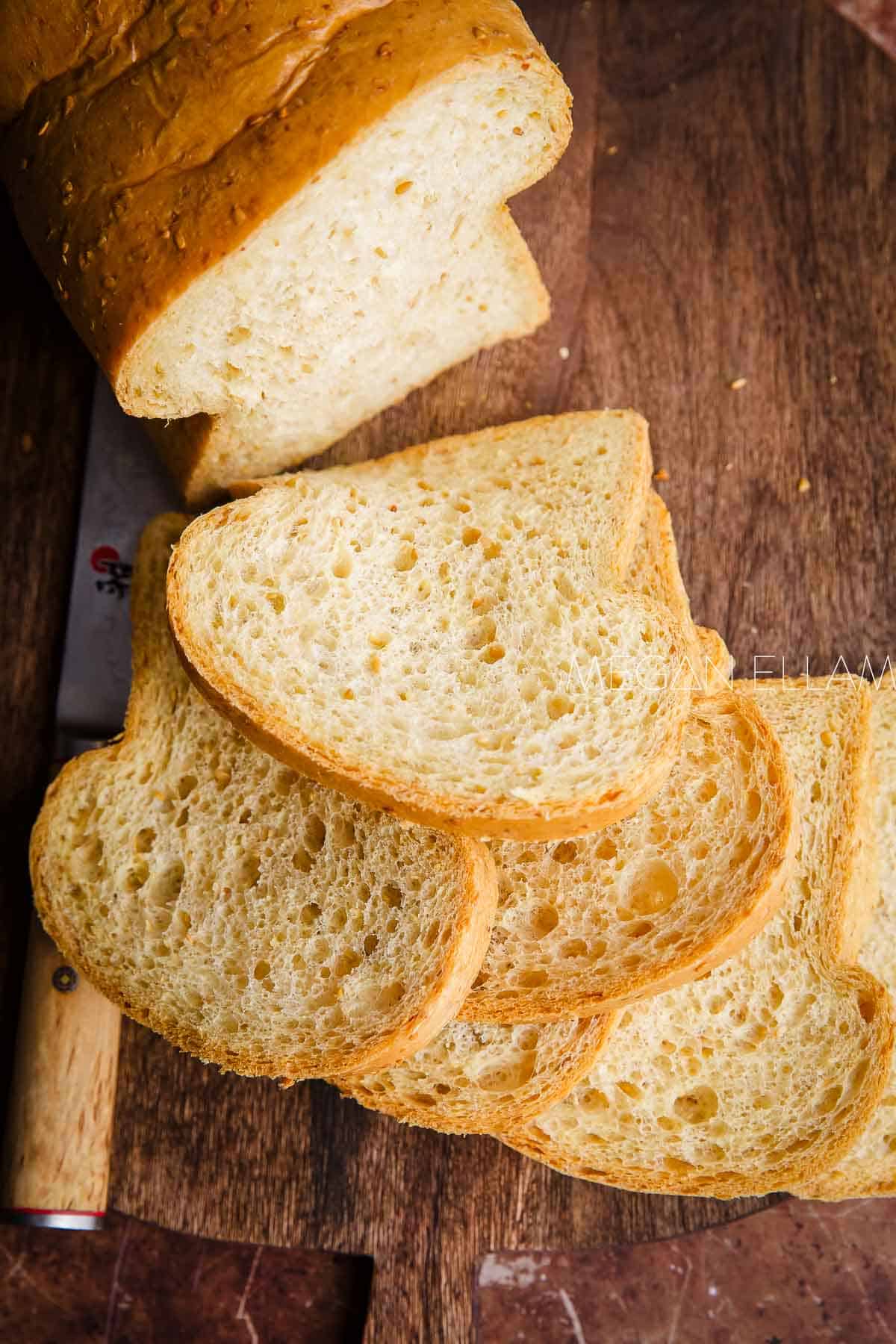 The best low carb bread recipe loaf sliced on a wooden cutting board.