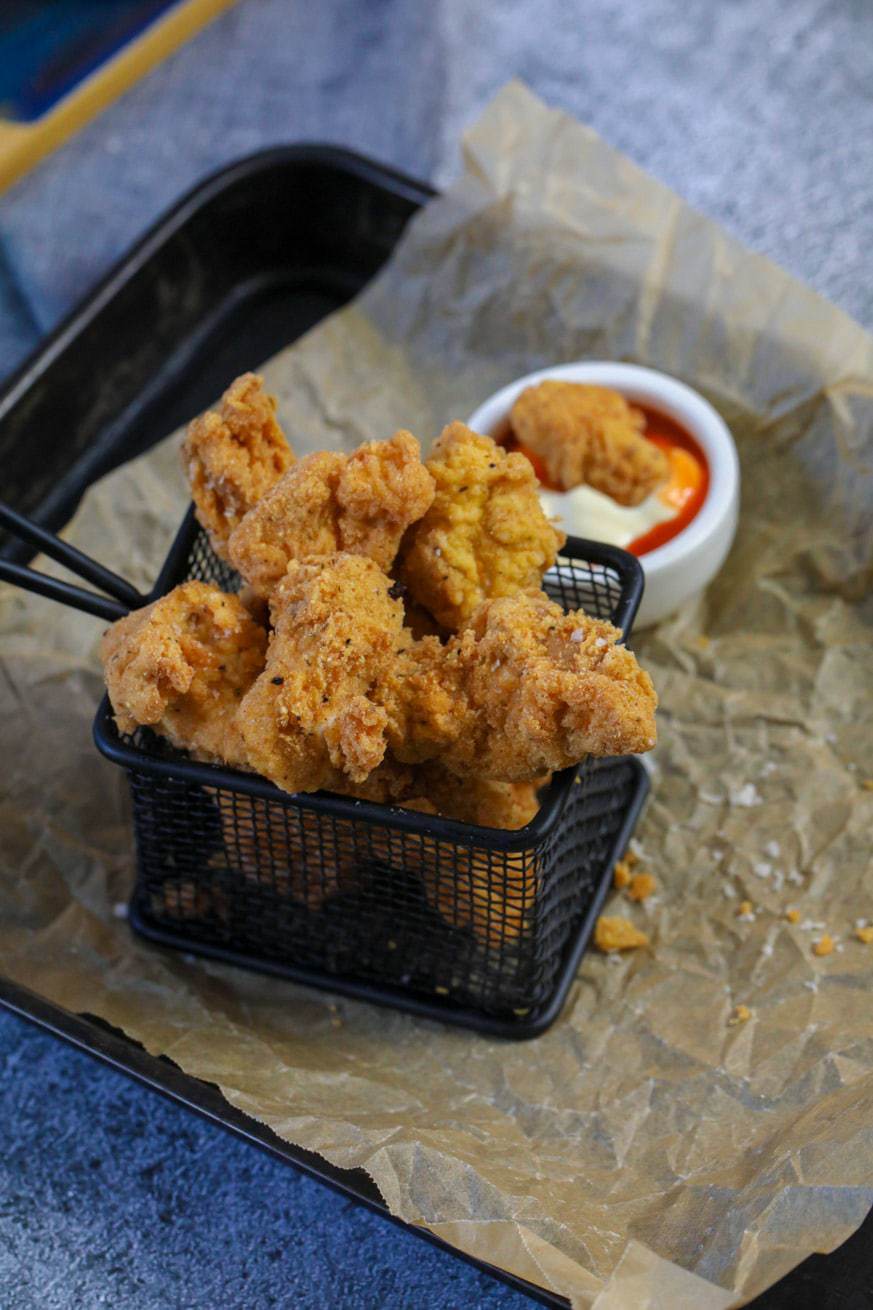 Mad Creations Keto Popcorn Chicken in a small fryer basket