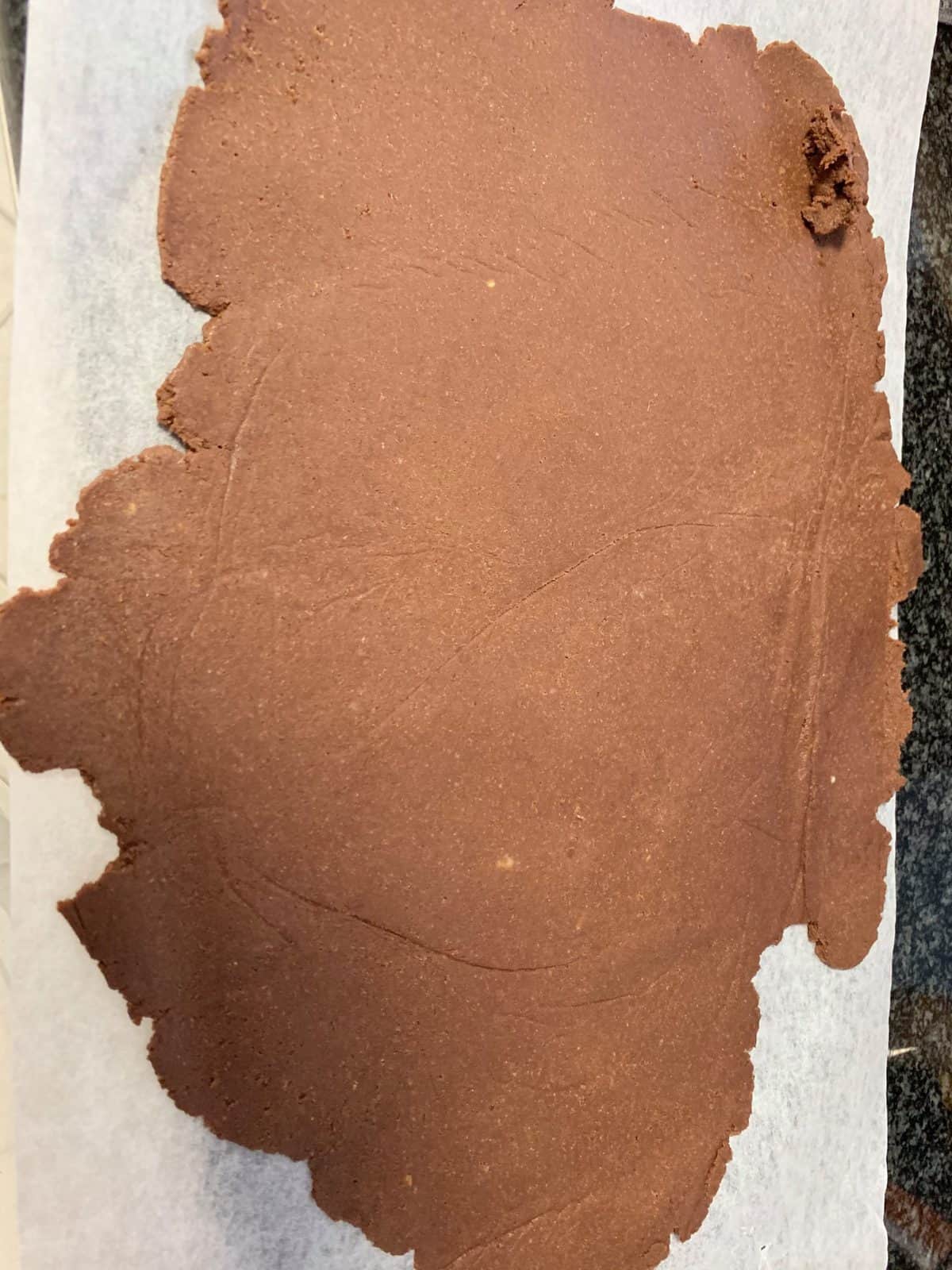 chocolate pastry rolled out on baking paper