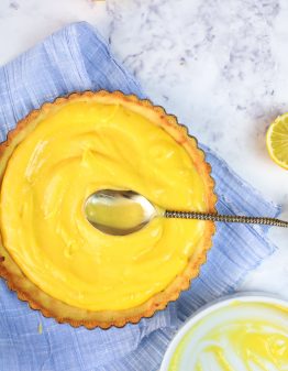lemon curd in a keto pie shell on a white backdrop
