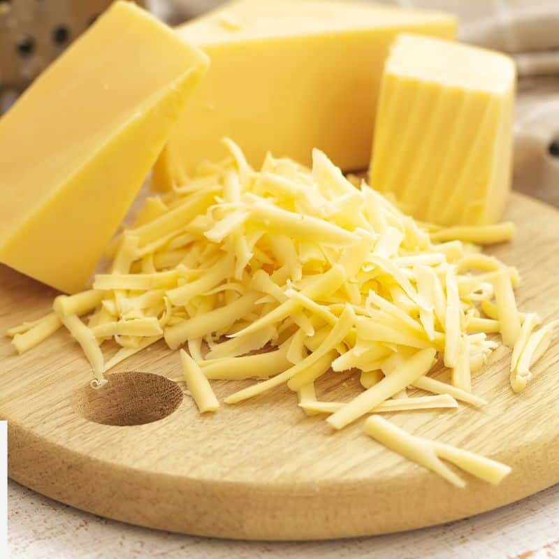 grated cheese on a cutting board