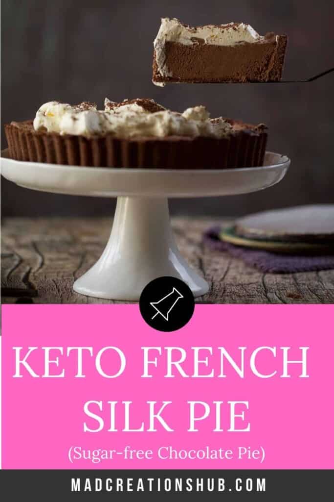 Chocolate pie on a white cake stand with a piece held above it