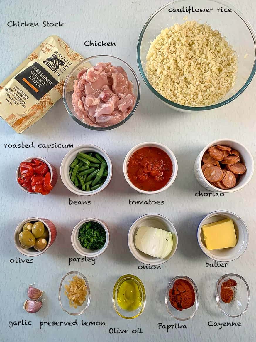 chicken and chorizo paella ingredients laid out on white background