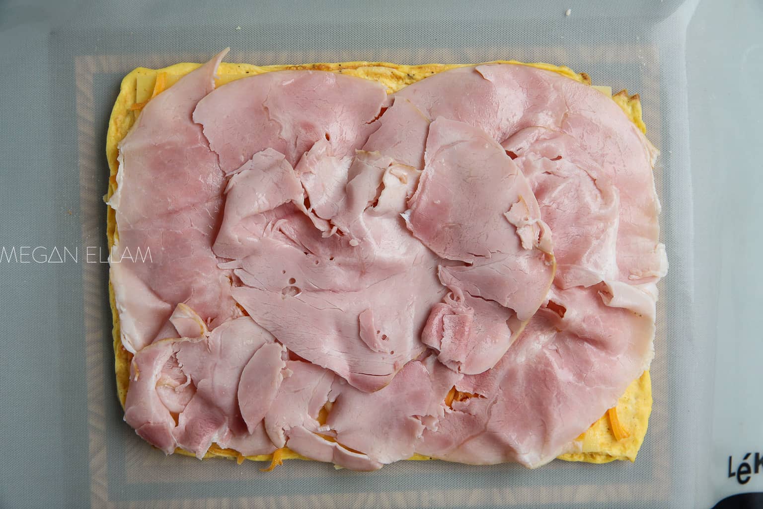 ham spread over baked eggs