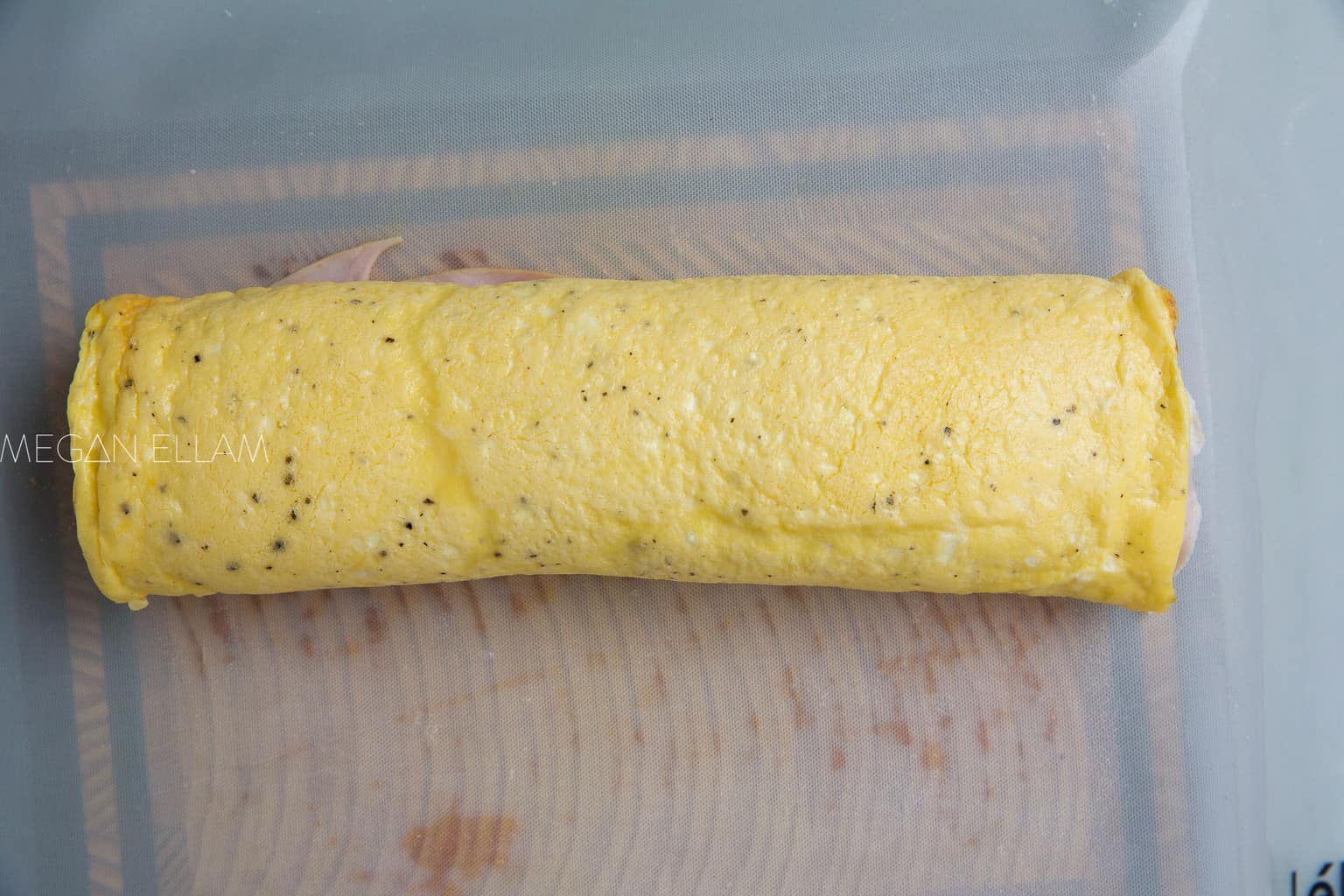 a rolled omelette on a silicone mat.