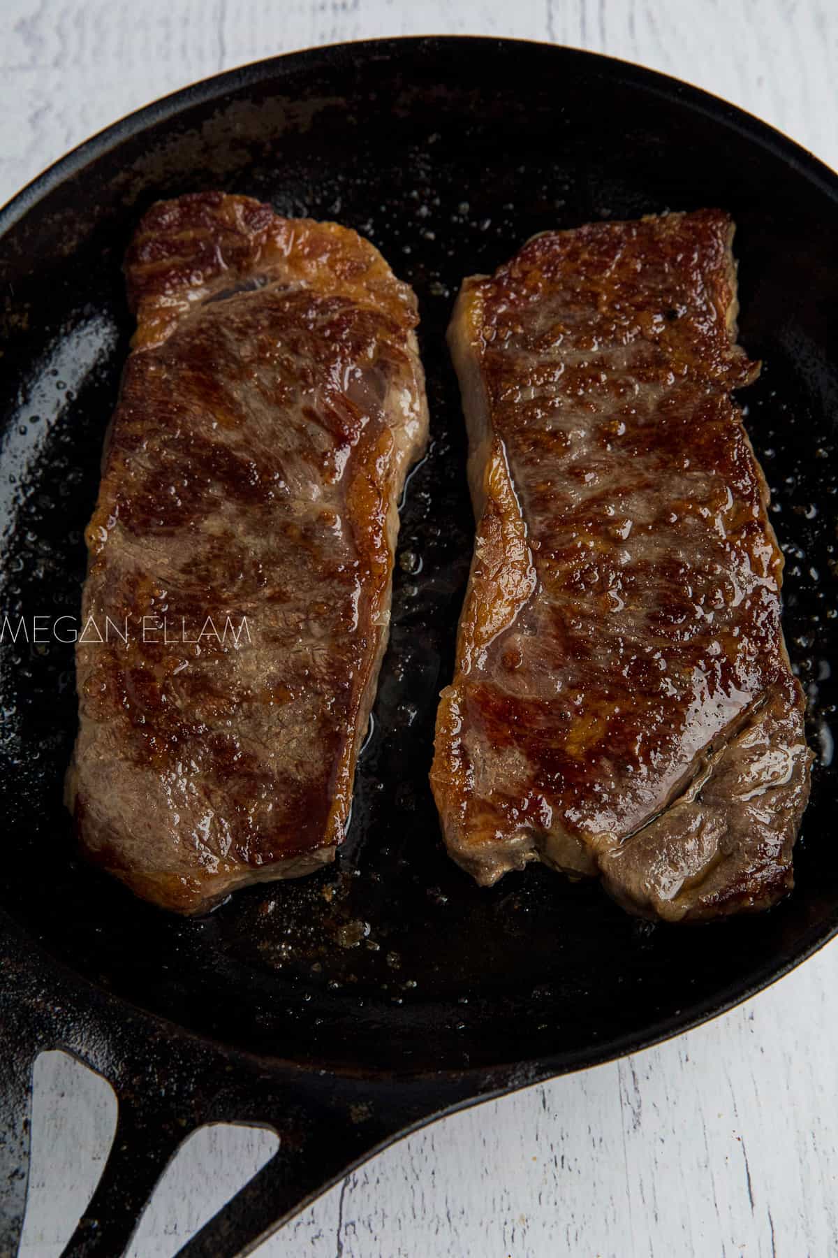 Cooked steak in a pan.