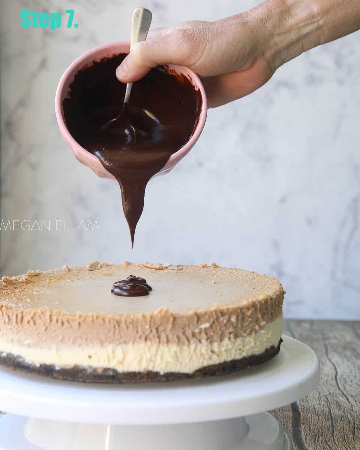 Chocolate pouring from a bowl onto cheesecake.