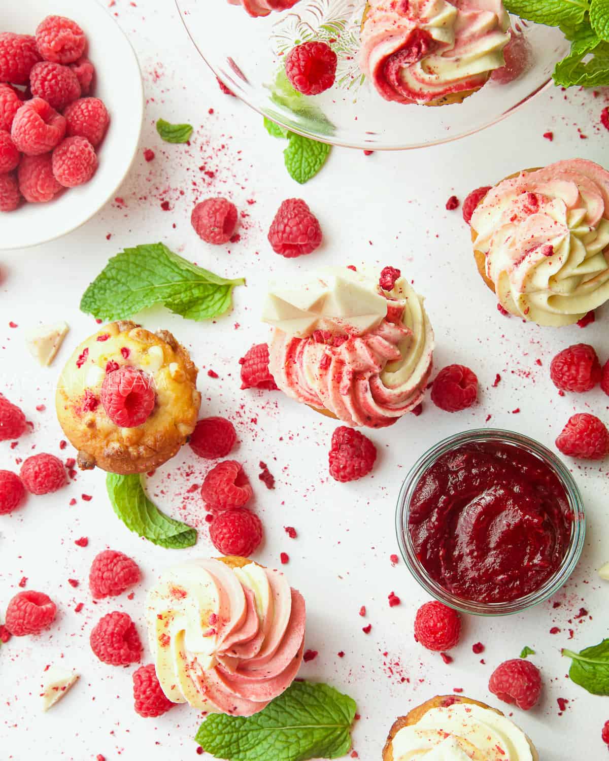 raspberry muffins, berries and mint on a white background.