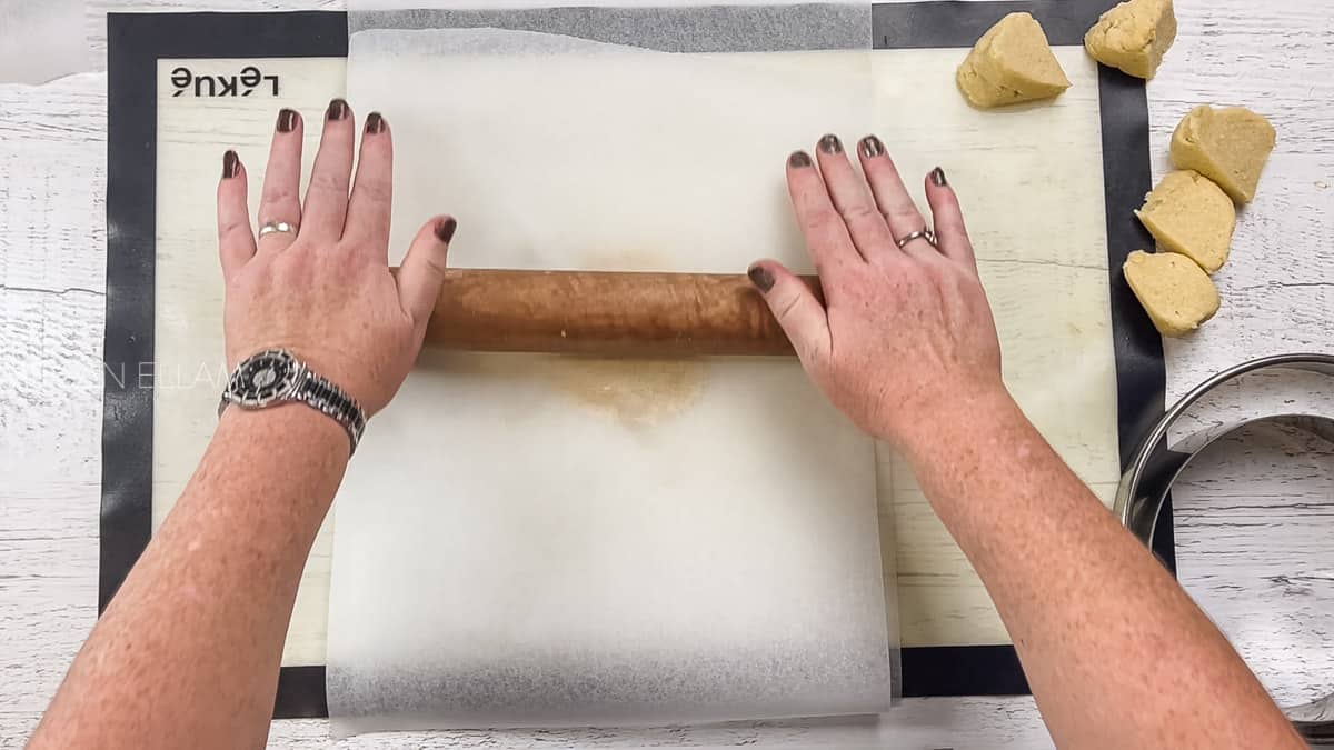 Rolling dough out with rolling pin.