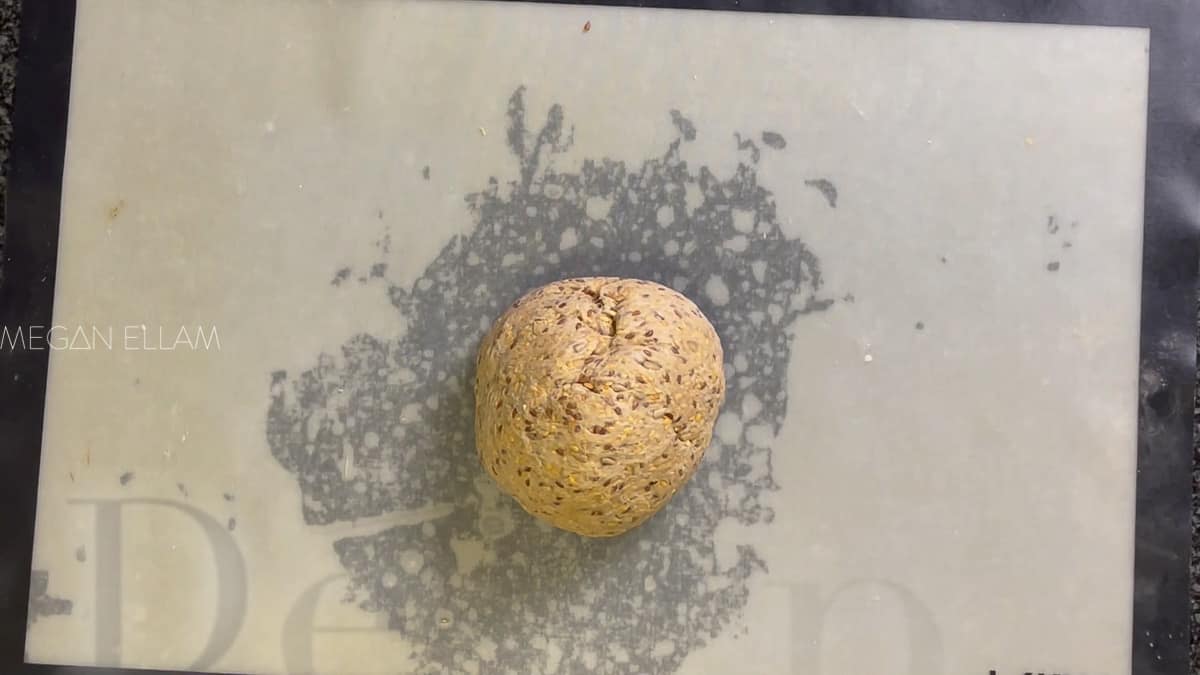 A dough ball on a silicone mat.