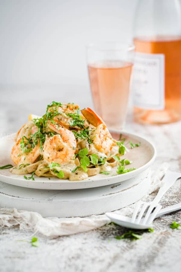 Prawn pasta on a plate with rose.