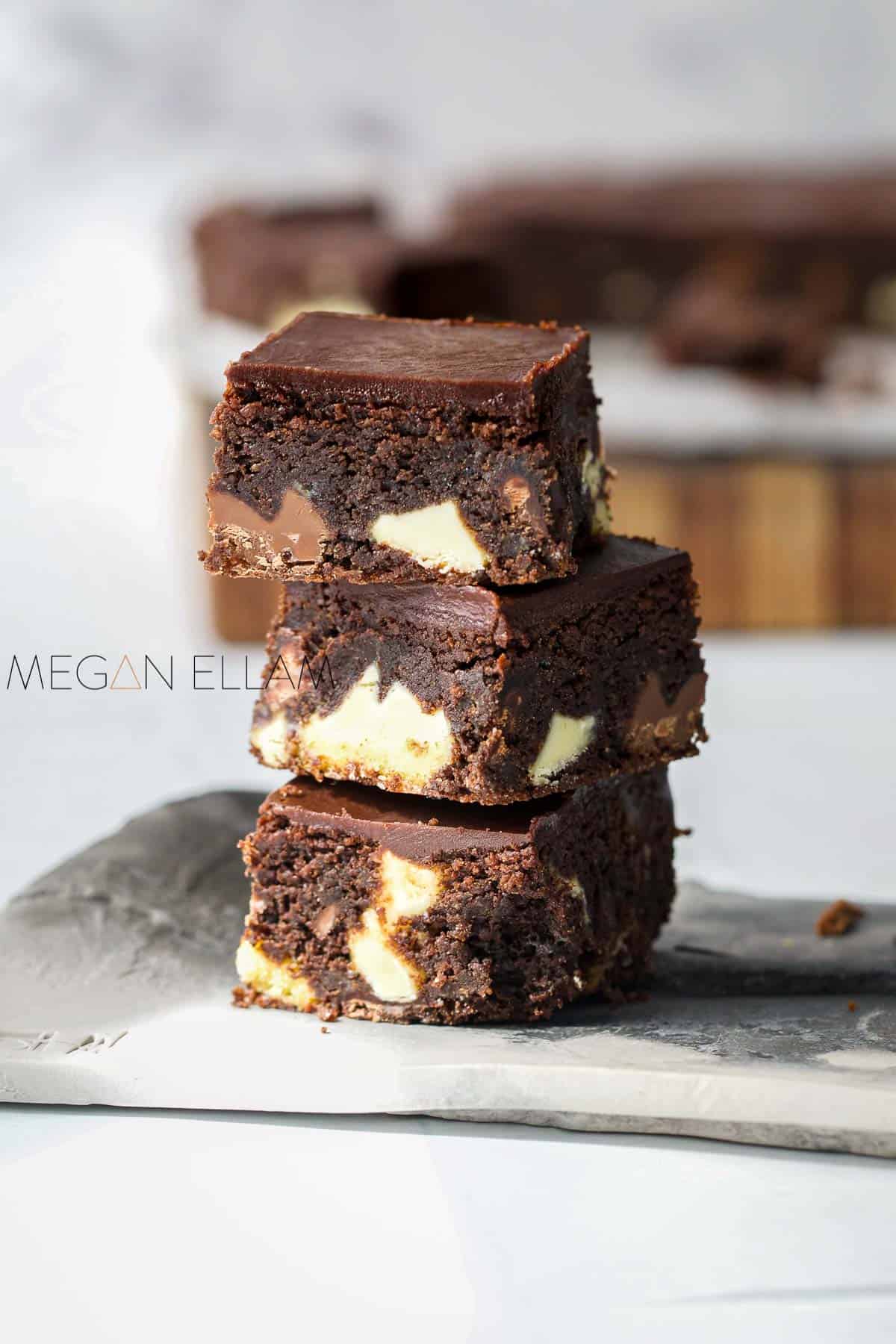 3 low carb brownies stacked on top of one another.