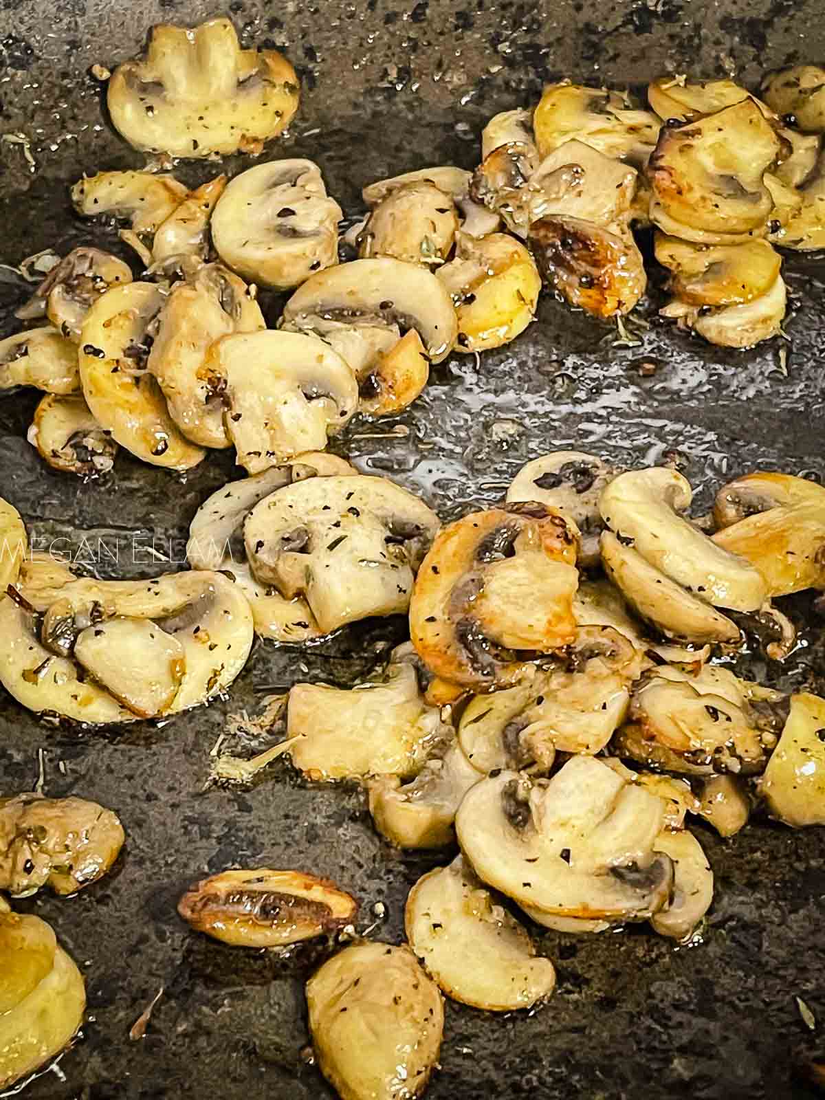 Sauteed mushrooms in a frying pan.