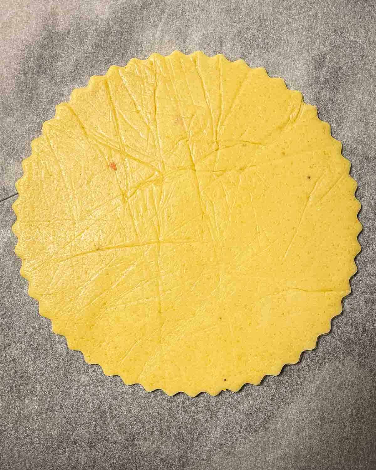 An uncooked Keto Fathead Pizza Crust on baking paper.
