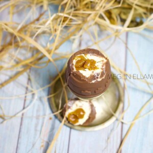 A close of a caramel filled keto easter egg in a silver egg cup.