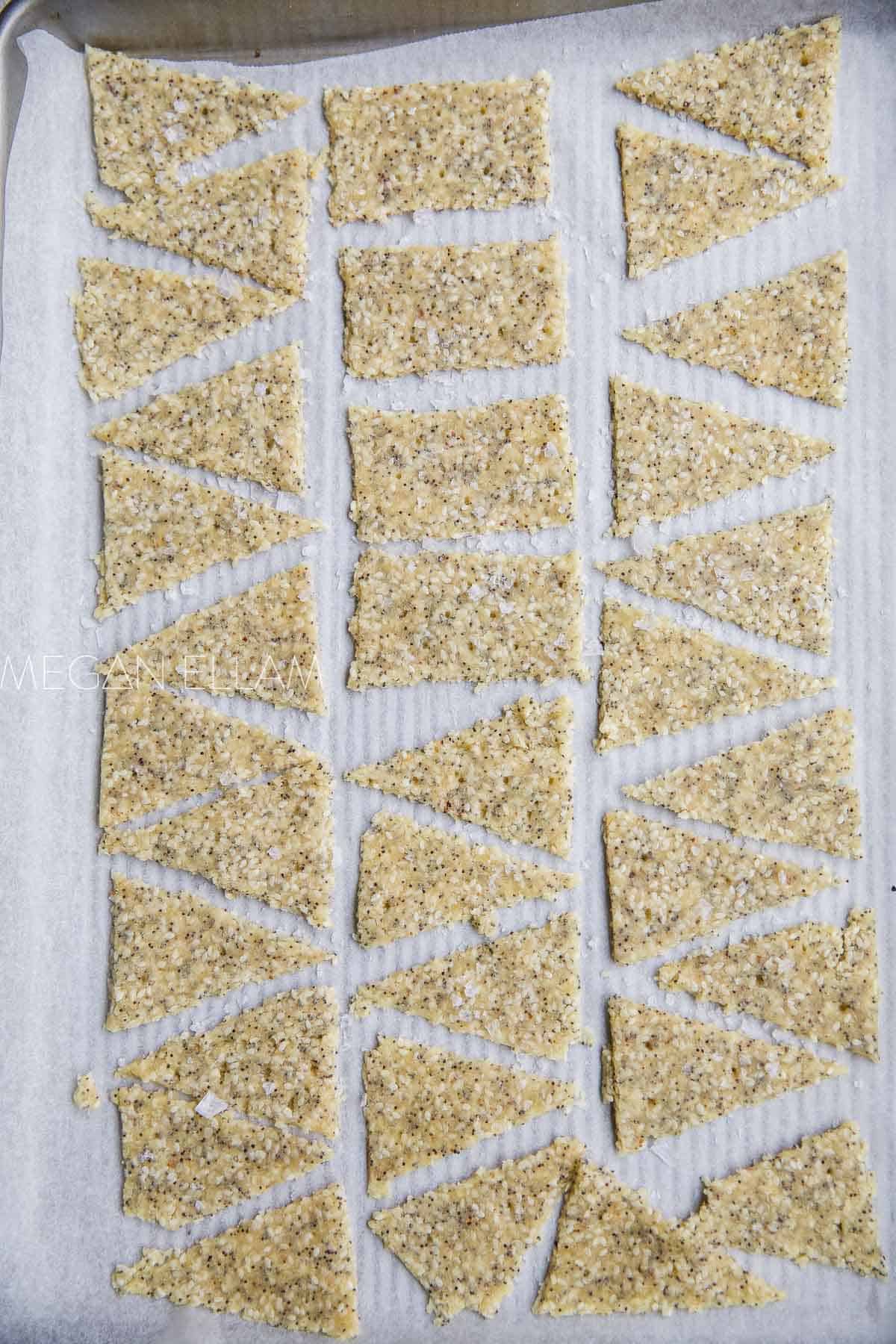 Raw rolled and shaped crackers on a baking tray.