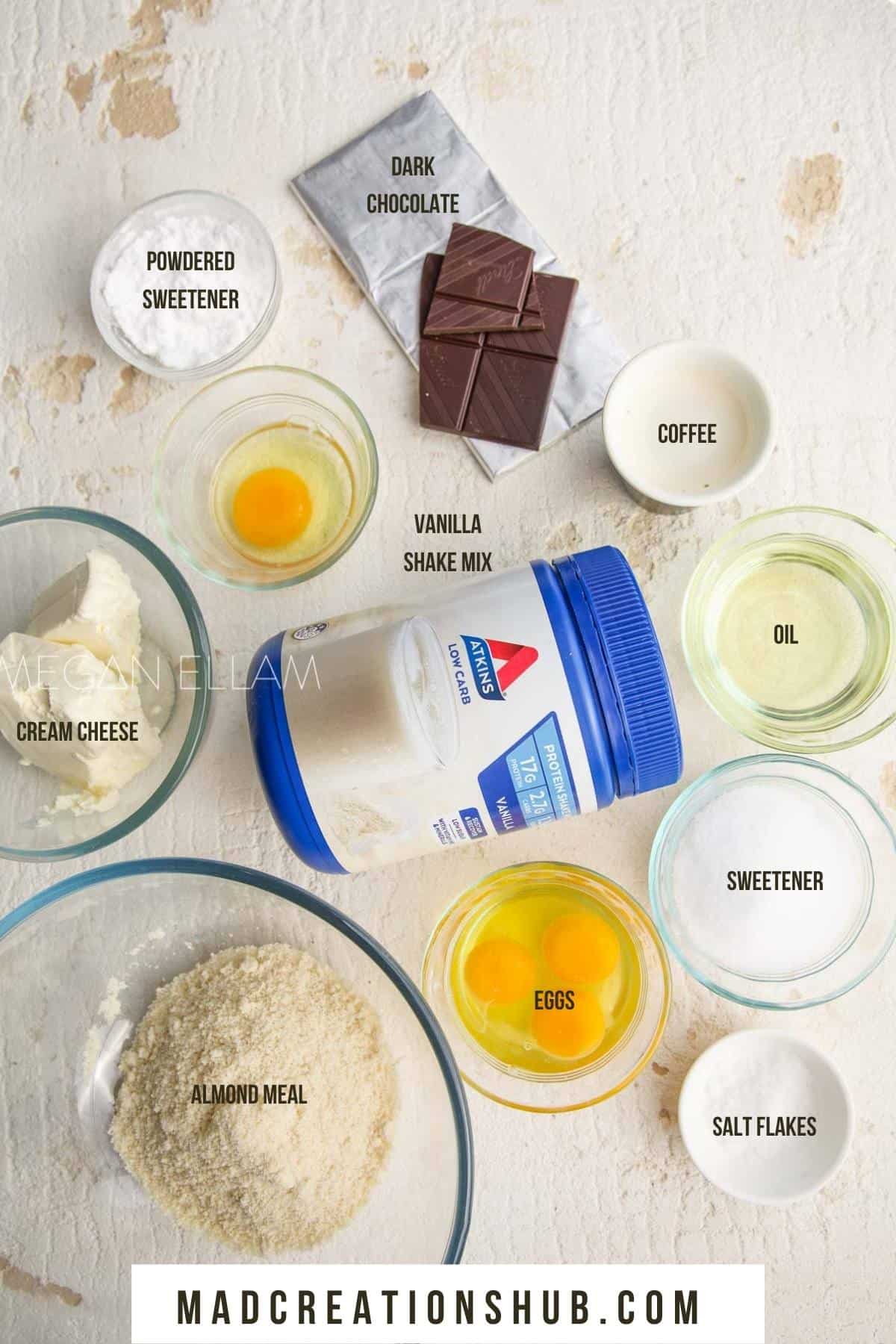 Chocolate Protein Brownies ingredients in small bowls on a white background.
