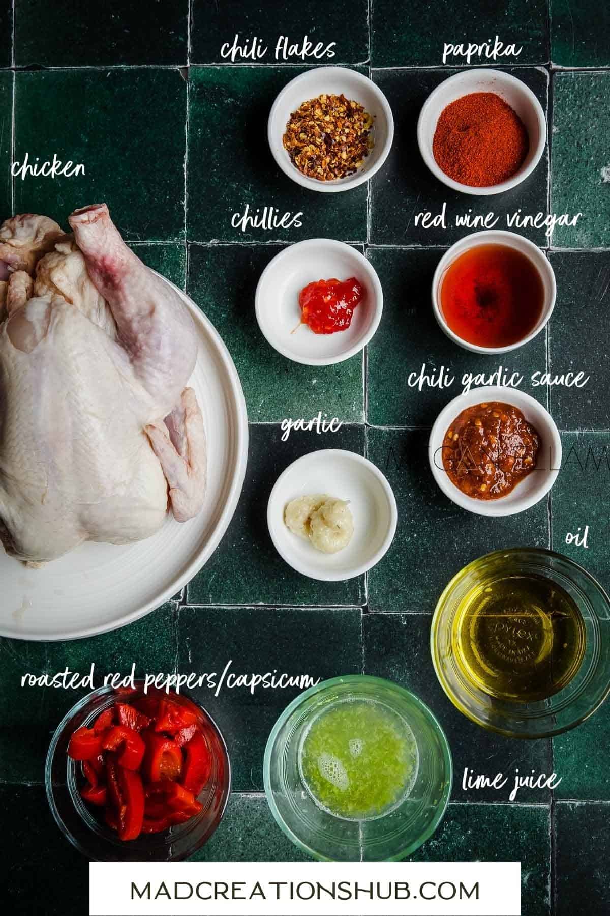 All the ingredients for Peri Peri Chicken on a green tiled backdrop.