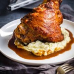 A pork hock cooked until golden and crispy on a bed of cauliflower mash and gravy.
