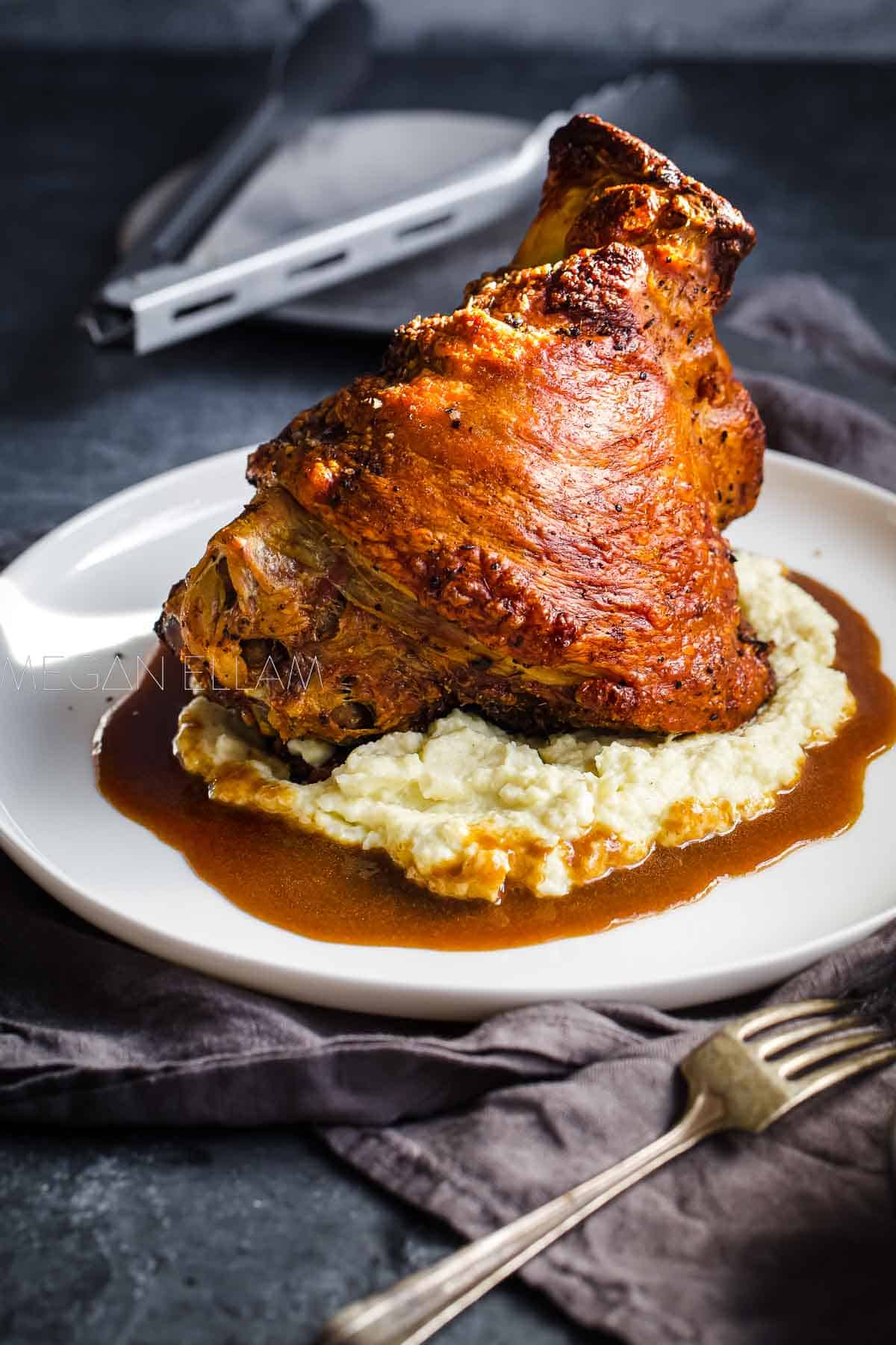 A pork hock cooked until golden and crispy on a bed of cauliflower mash and gravy.