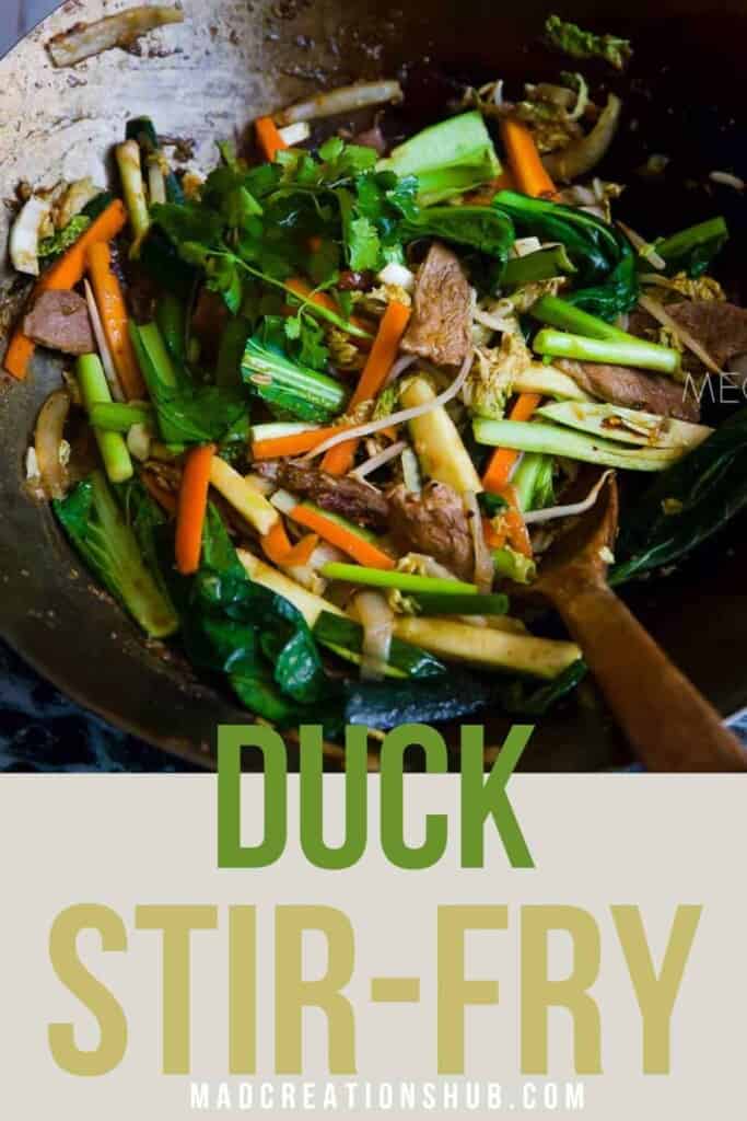 A close up of duck sir fry in a wok.