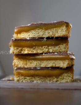 Keto Caramel Slice stacked on top of one another.
