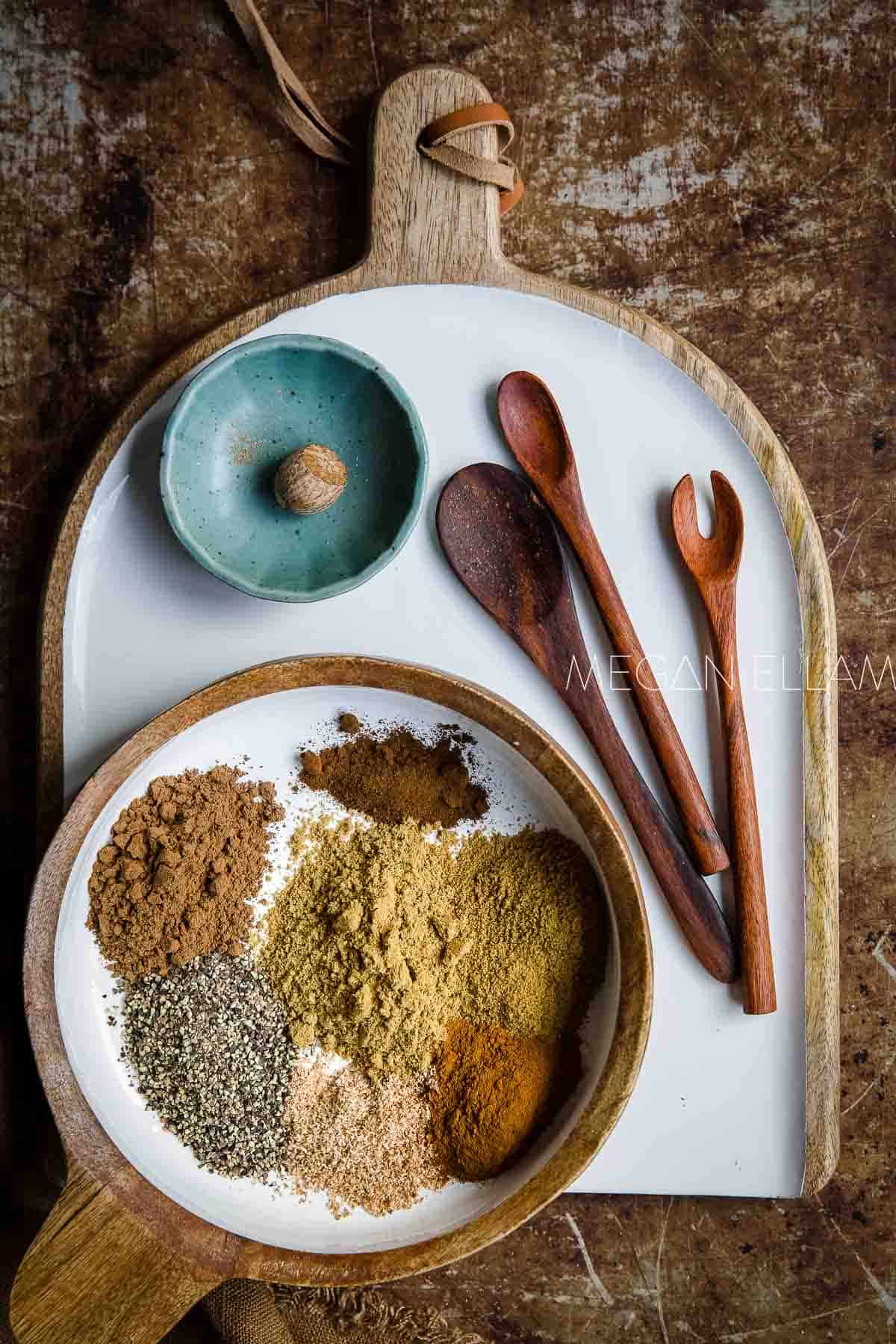 A white and wood bowl with Lebanese seven spices inside it before mixing together.