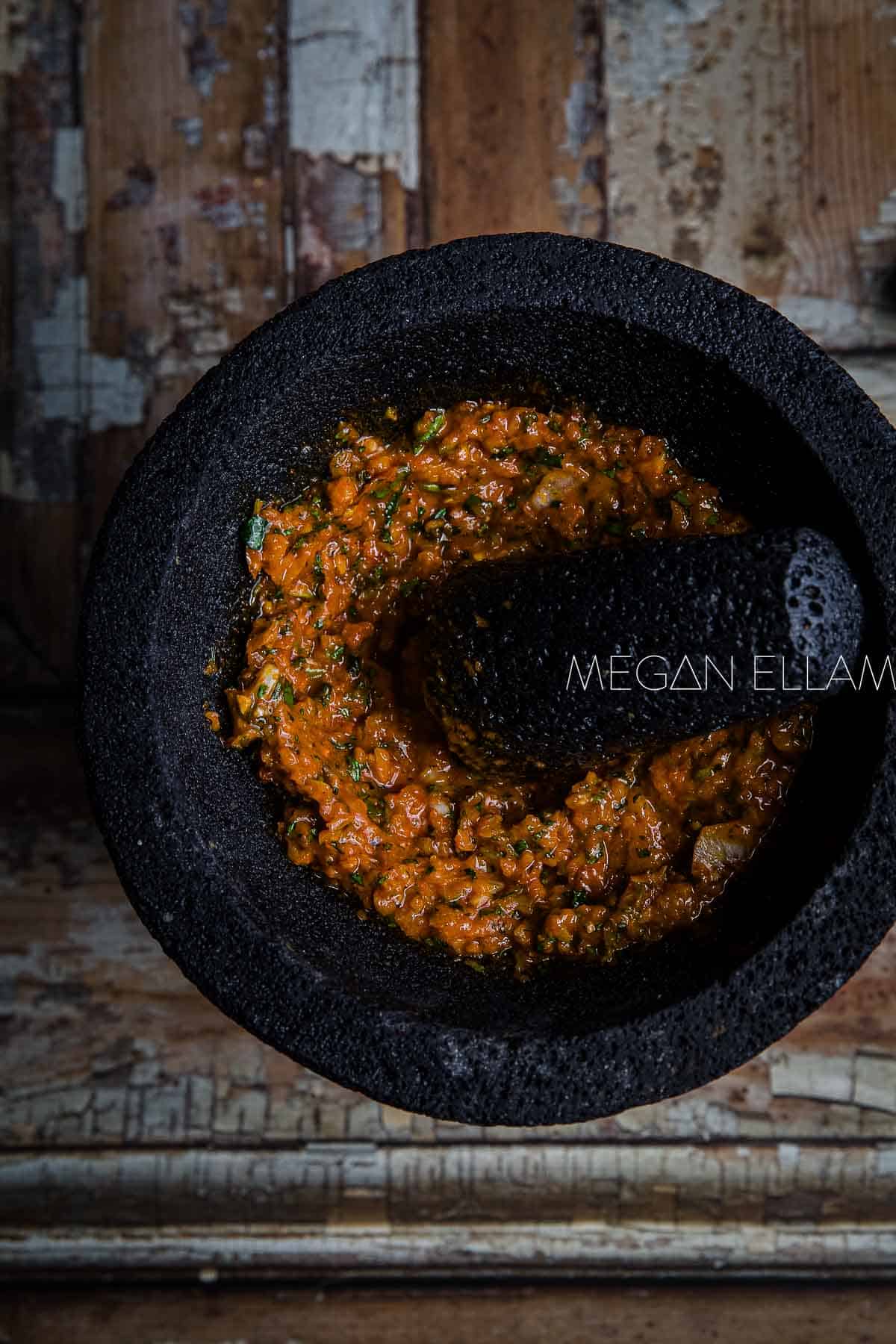Red Curry Paste in a black mortar with pestle.