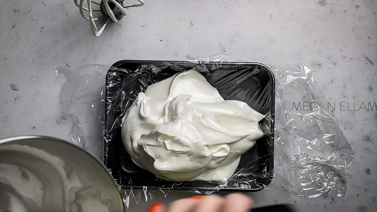 Whipped marshmallow in a lined tray.