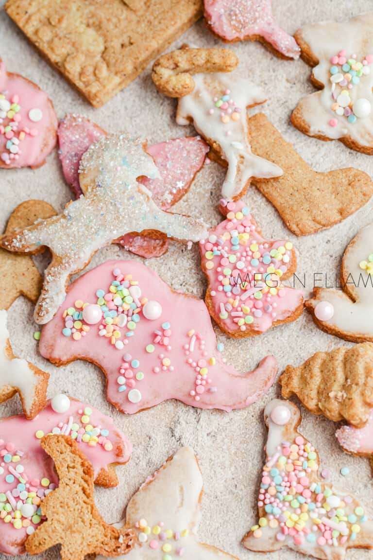 Keto Gingerbread Animal Crackers coated in pink and white glaze and sprinkles.