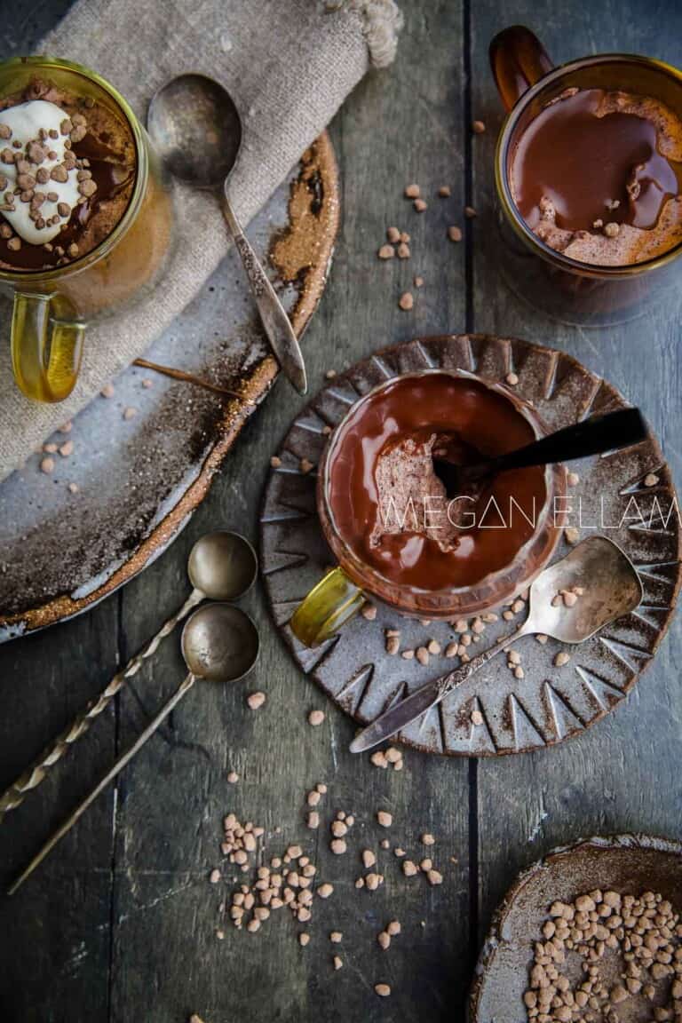 Three glasses of chocolate low carb mousse on a wood table.